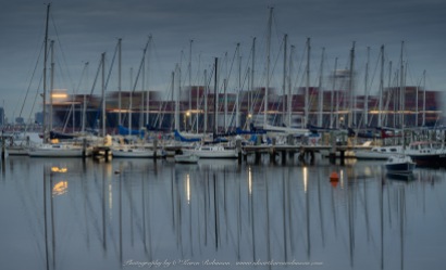 Williamstown, Victoria - Australia 'Early morning at Ferguson Street Pier looking out across Port Phillip Bay' Photographed by Karen Robinson July 2019 Comments - Cold winter's morning catching the sun rising - Cargo Ship passing by behind docked yachts.